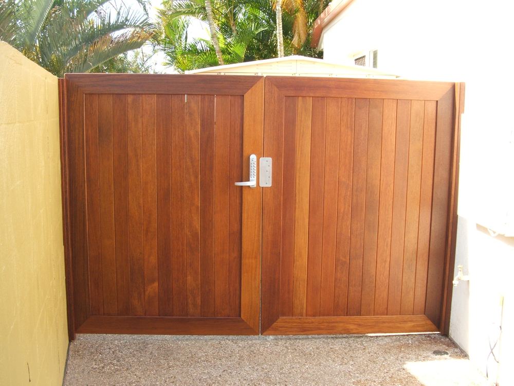 Double Kwila side gate doors set into a rendered wall