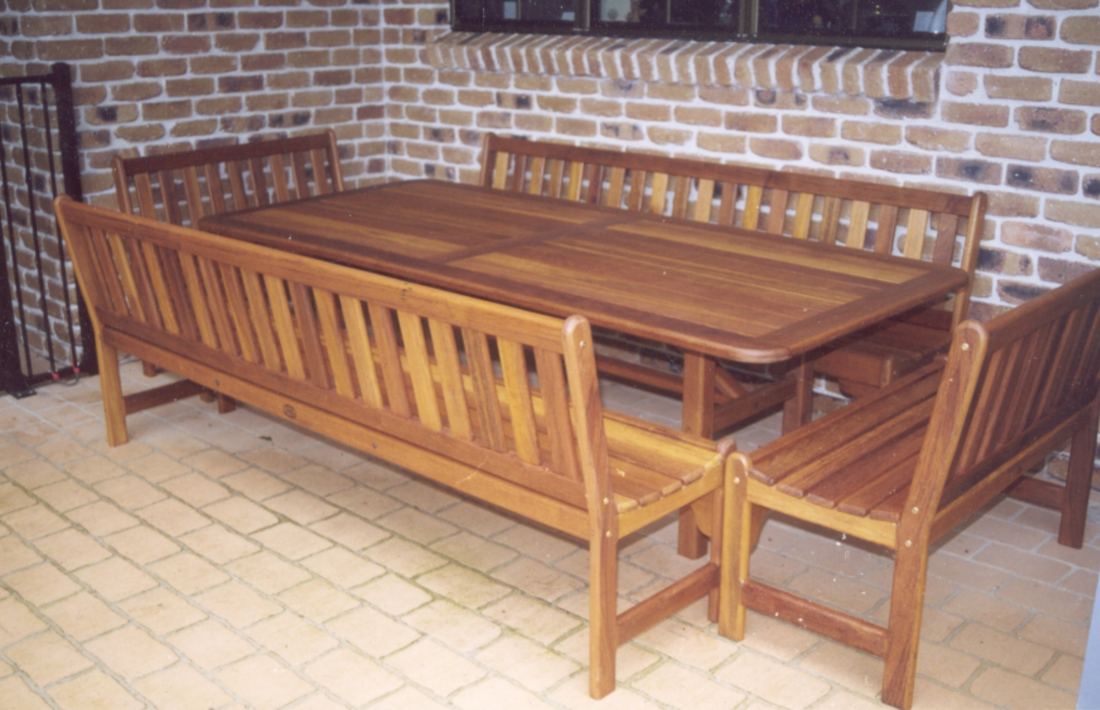 Kwila table with Kirra benches with backs against a brick wall