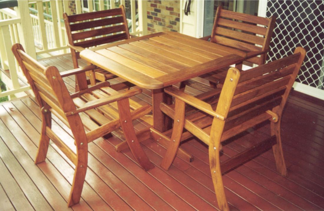 Square Kwila table with four Laguna chairs on a deck