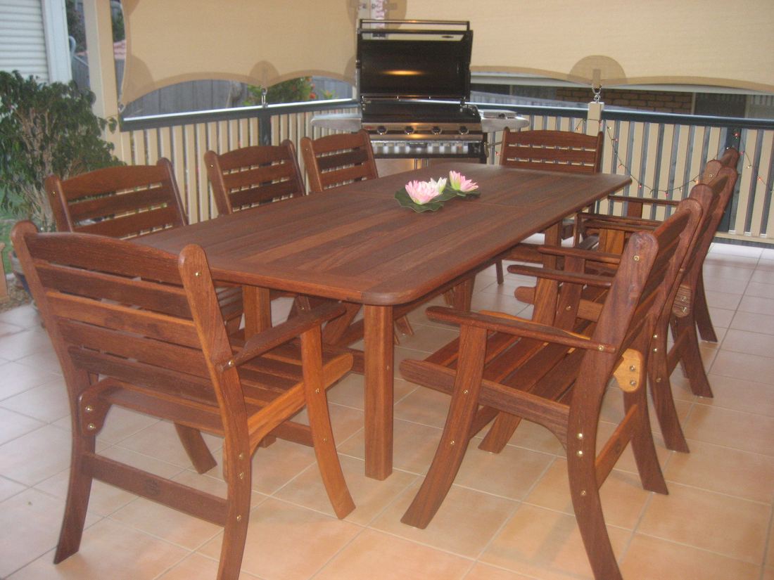 Long Kwila table with Laguna high back chairs beside a built-in barbecue